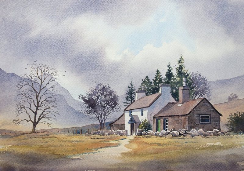 A whitewashed stone cottage with a slate roof and a bare tree, in the Ogwen Valley