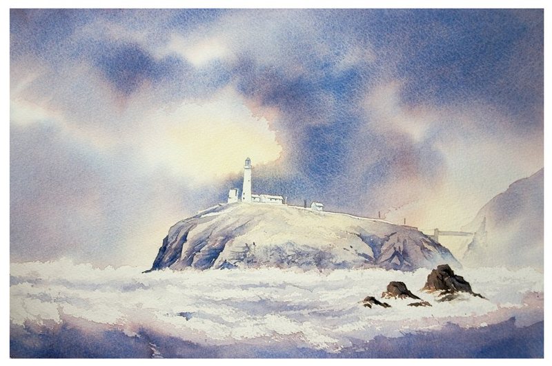 South Stack lighthouse on its rocky island above a sea of white surf, under a stormy sky